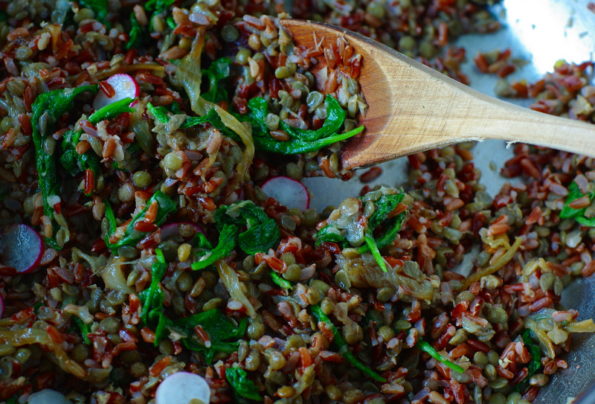 Red rice with bright green leaves running through it.