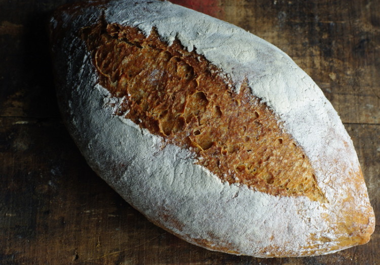 A rustic flour covered, oblong loaf.